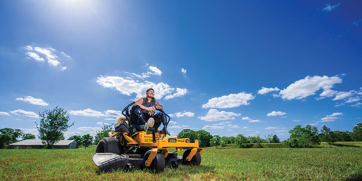 A woman mowing her 5 acres