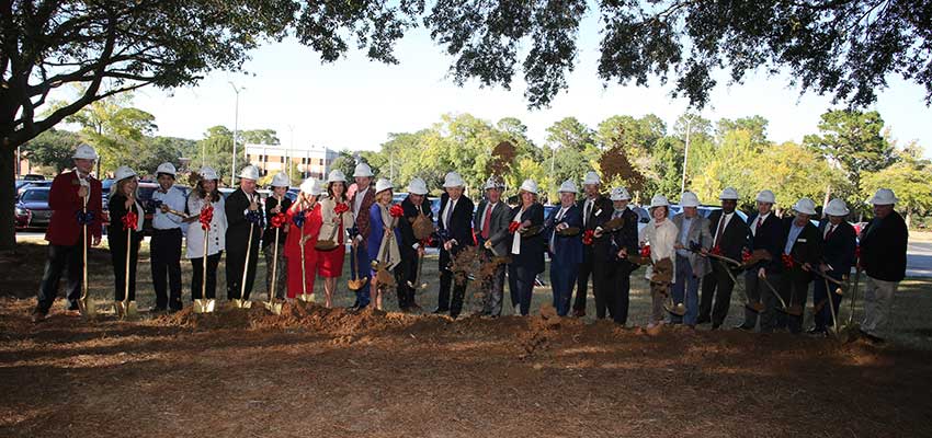 People with shovels at groundbreaking ceremony