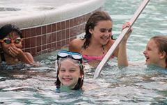 Kids smiling and laughing in pool.