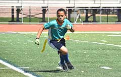 Young boy playing flag football.