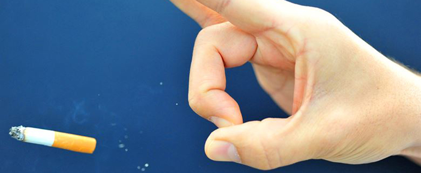 Hand flicking a cigarette 