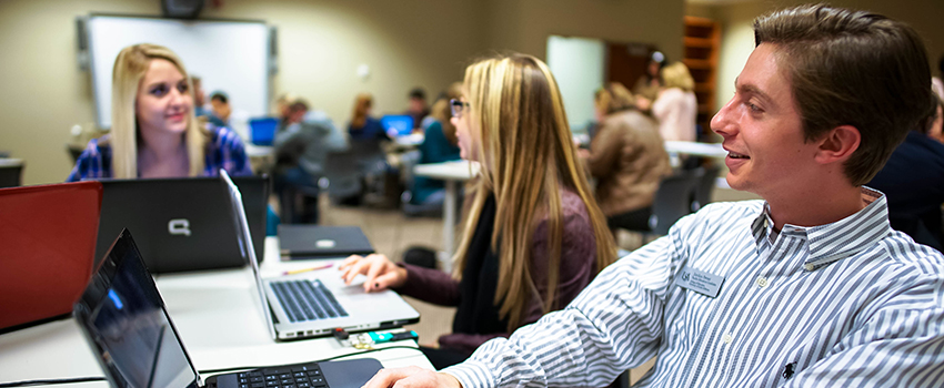 Three students working on their computers