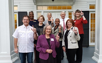 Outstanding employees with Dr. Walrop and wife in front of his house