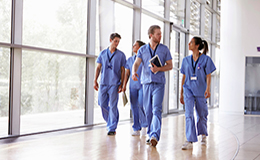 Medical staff walking the halls talking.