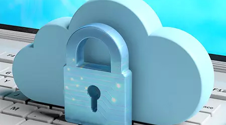 Cloud with lock on it sitting on a keyboard.