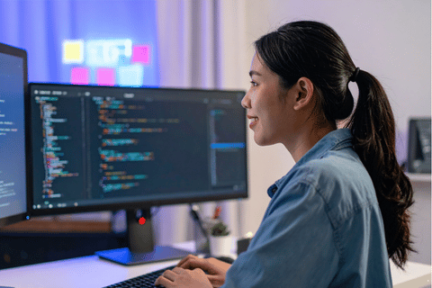 A woman smiling at a desktop