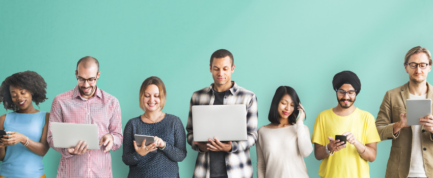 A group of people holding laptops, notebooks, and phone.