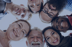 People working together with arms around each other from the back.
