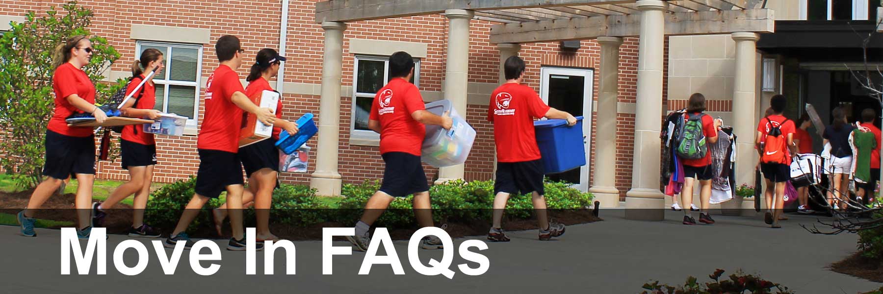 Students carrying items to move into dorms.