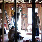 People working to rebuild a house after Hurricane Katrina