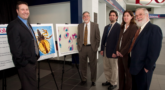Grant Recipients – The NIH grant will support numerous research projects at the University dedicated to the prevention and treatment of infectious diseases. Researchers in the department of microbiology and immunology discuss the award announced at a Feb. 5 press conference. From the left are Dr. Paul Brett, assistant professor; Dr. David Wood, chair; Dr. Jonathon Audia, assistant professor; Dr. Mary Burtnick, assistant professor; and Dr. Herb Winkler, Louise Lenoir Locke Distinguished Professor of Microbiology and Immunology. 