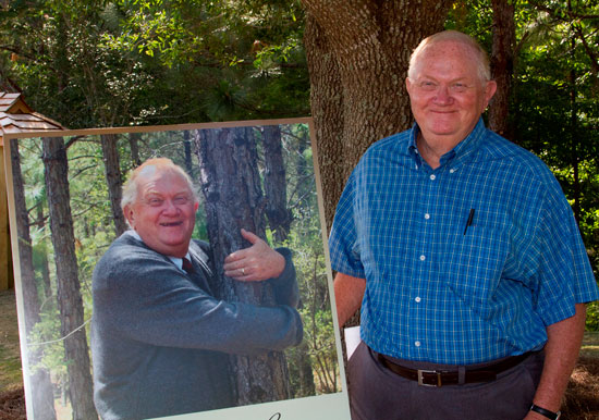 Sebastian Remembers-Professor Emeritus Dr. Glenn Sebastian stands next to a photo taken of him many years ago and shares memories of enjoying the nature trail that’s been recently named in his honor. 