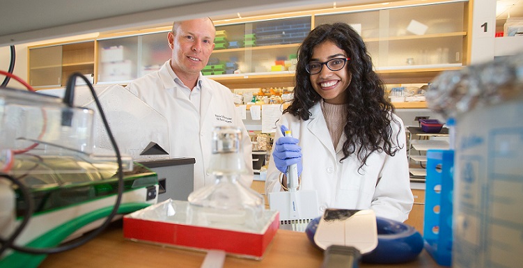 Pooja Revanna, a junior Honors student, works with her mentor, Dr. Peter Sykora, at a USA Mitchell Cancer Institute lab. 