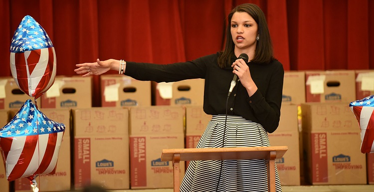 Alicia Duke speaks to students at Dothan's Cloverdale Elementary School about The Little Heroes project. Duke returned to her hometown in April to announce that donated food would help children through the end-of-the-year testing period. Photo courtesy of the Dothan Eagle, photographer Danny Tindel.