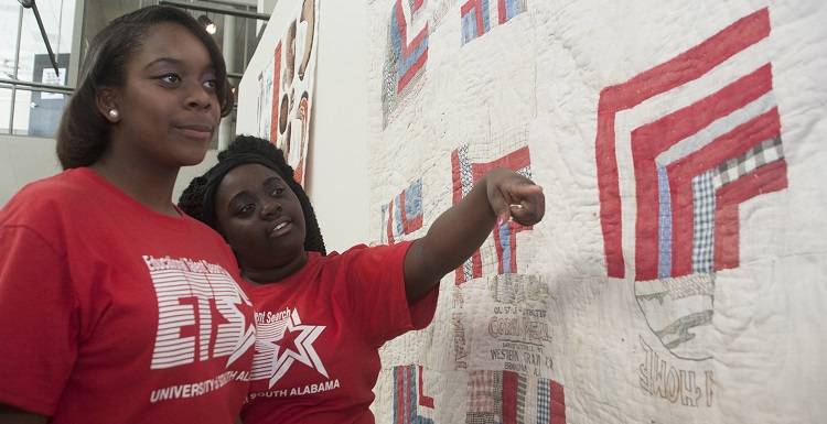 The College of Education and Educational Talent Search at the University of South Alabama recently partnered to introduce the arts into a math and science summer program for middle and high school students. Danielle Johnson, Mary G. Montgomery High School, left, and Yekina Adams, Pillans Middle School, view the Gees Bend quilt exhibit at the Alabama Contemporary Arts Center.