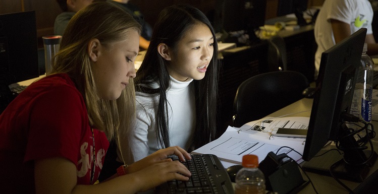 Emily Martin, left, and Tu Anh, work on encryption assignments during GenCyber Camp held at USA's School of Computing. They and other rising 9th Graders at Davidson High School participated in the week-long program.