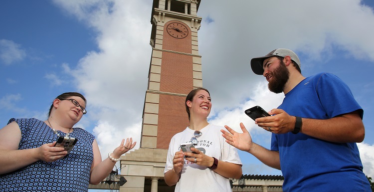 Dr. Stephanie Jett, left, visiting assistant professor of psychology, shares Pokémon Go tips with Susan and Chandler Grimsley at Moulton Tower, where students and others flock to hunt for Pokémon. Susan Grimsley is a 2012 graduate of South with a master's degree in accounting. data-lightbox='featured'