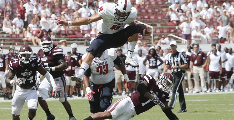 Dallas Davis leaps over Mississippi State defenders in the Jags 21-20 victory in Starkville, Miss.