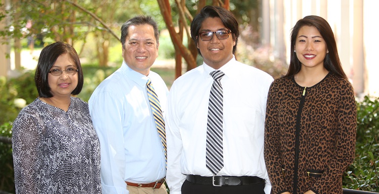 Christian Manganti, second from right, who scored a perfect 36 on his ACT college assessment test, is the 2016-17 USA Board of Trustees Scholar. Manganti's parents, far left, and Shirley Zhang, last year's winner, attended Friday's Board of Trustees meeting.