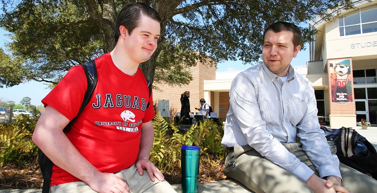 Passage USA student sitting with instructor outside Student Center