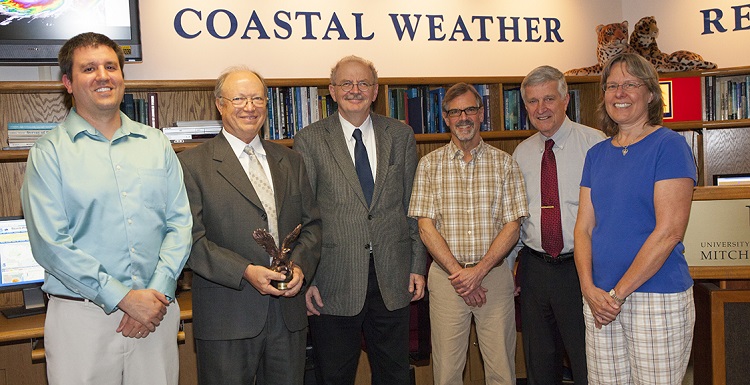 Congratulating Dr. Keith Blackwell, second from left, on his award from CSX were Andrew Murray, instructor of meteorology and Coastal Weather Research Center hurricane specialist; Dr. Andre Wierzbicki, dean of arts and sciences; Pete McCarty, director of the Coastal Weather Research Center; Dr. Bill Williams, director emeritus; and Dr. Sytske Kimball, chair of meteorology. 