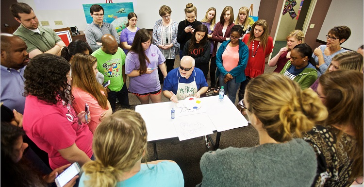 Each year, South graduate and artist Ricky Trione visits classes in the College of Education. A lesson quickly emerges: If a blind man can create boldly colored, vibrant paintings, and sit on the floor of a classroom teaching kindergarteners how to do the same, then teachers can use art to communicate with almost anyone.