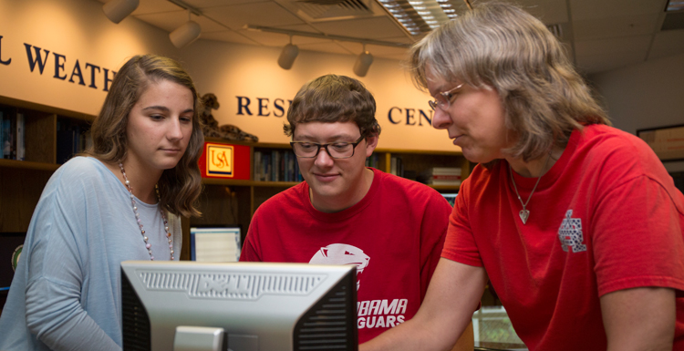 Dr. Sytske Kimball, chair of meteorology, right, discusses research projects with Caroline Kolakoski and Dillon Blount, two of the four South students named as recipients of the prestigious Hollings Scholarships. Caitlin Ford and Sam Sangster are also recipients.