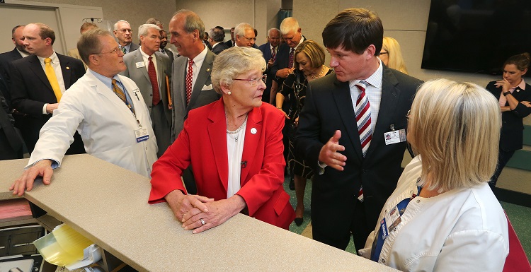 Gov. Kay Ivey, center, tours the University of South Alabama Medical Center and talks with Sam Dean, hospital administrator, before announcing a $4 million bond issue to renovate and expand the hospital’s Level 1 Trauma Center.