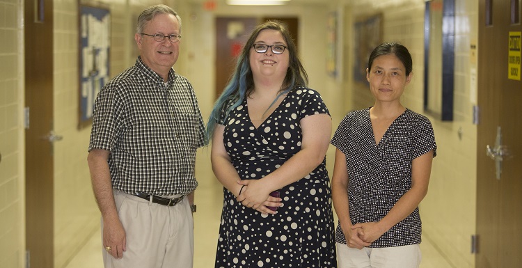 Lindsay Hutcherson, center, participated in a summer research experience at Kansas State University, the alma mater of Dr. Justin Sanders, left, chair and associate professor of physics in the College of Arts and Sciences. "She is very good at working collaboratively with others," said Dr. Jianing Han, right, assistant professor of physics.