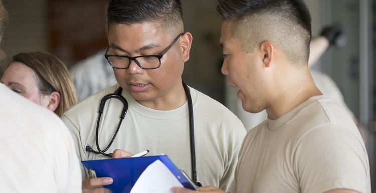 Capt. Rupert Laco, center, a South doctoral nursing program student is the recipient of the American Nurses Association-California 2016 Florence Nightingale Award. He is seen being briefed about one of his patients. Photo courtesy of the U.S. Air Force.