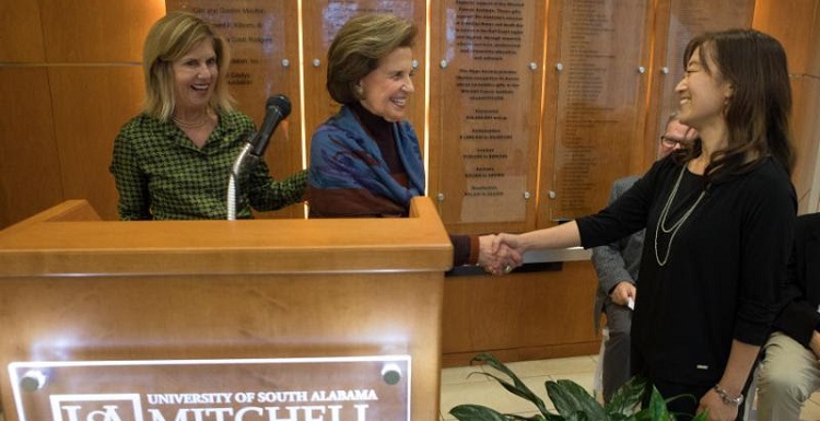 Dr. Erin Eun-Young Ahn, right, is congratulated by USA Trustee Arlene Mitchell, wife of the late Mayer Mitchell. She is joined by Vice President for Development and Alumni Relations Margaret Sullivan. 