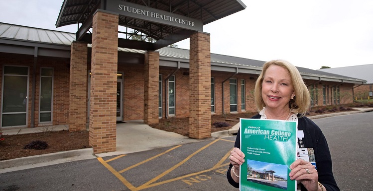 Beverly Kellen, director of operations for the USA Student Health Center, holds a recent edition of the Journal of American College Health featuring USA's Student Health Center.