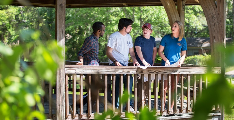 University of South Alabama senior design project team members, from left, Ali Alshehri, Martin Aquirre, Jacob Franklin and Emily Robertson review their redevelopment plans for Stewart Park. Theirs was one of four teams of South engineering students whose senior design project was to redesign components of selected city properties in Mobile.