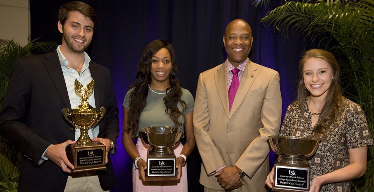 Vice President for Student Affairs and Dean of Students Dr. Michael Mitchell, right center, presents the 2018 Dean's Cup award to University of South Alabama Greek organizations for outstanding service and leadership. From left are Carson Davidenko, president of Pi Kappa Phi Fraternity; Madison Rutledge, president of Alpha Kappa Alpha Sorority, Inc.; and Brooke Qualkenbush, 2016-2017 president of Alpha Omicron Pi Fraternity.  