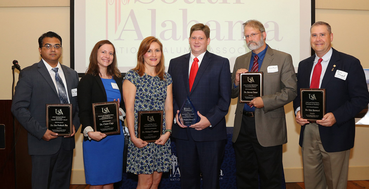 Recipients of the Alumni Awards display their plaques.