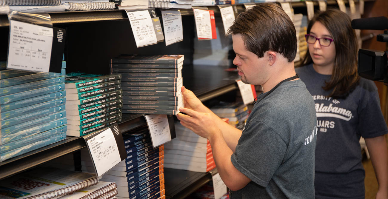 Benjamin Pelham, the recipient of the 2018 Dan Piper award by the National Down Syndrome Society, is the first student admitted to the PASSAGE USA program at South, where he also works at the University of South Alabama Bookstore. Here he is with Carol Hudak, his peer mentor and a junior elementary education major. 