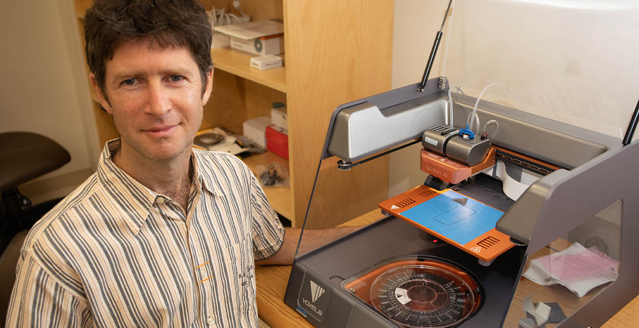 Dr. Mark Yampolskiy, assistant professor in the School of Computing pictured with 3D printing device