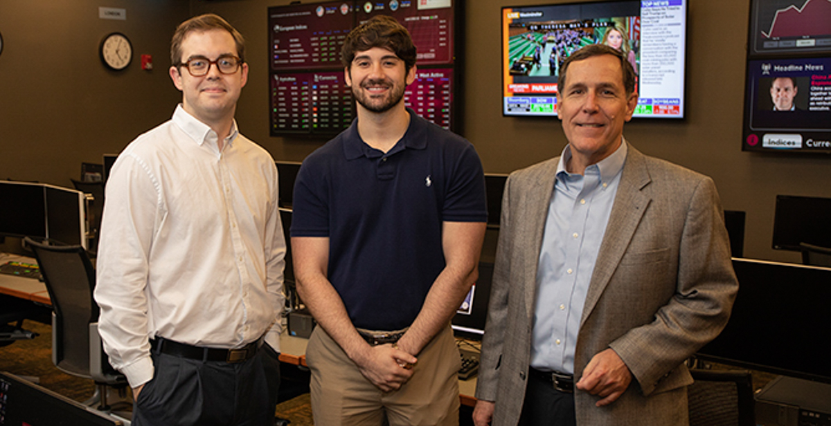 Jacob Corbett, left, and Taylor Shepherd, center, are two of the six Mitchell College of Business students on a team that won the 2018 University Portfolio Challenge. Dr. Reid Cummings, director of USA’s Center for Real Estate and Economic Development, and the team’s mentor, right, taught the Finance 446 class each of the students took.