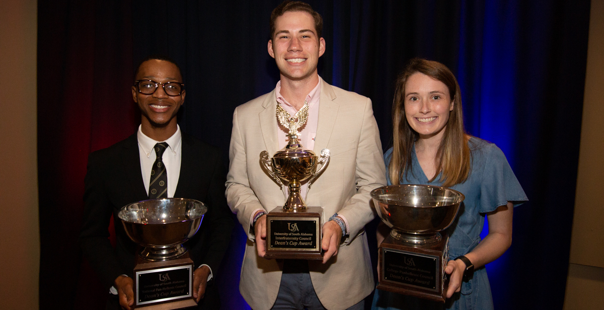 The University of South Alabama Greek organizations are awarded the Deans Cup for their outstanding service and leadership. From left, Michael Simmons, president of Alpha Phi Alpha Fraternity; Nolan Ricketson, president of Sigma Chi Fraternity; and Albany Wisner of Chi Omega Fraternity. 