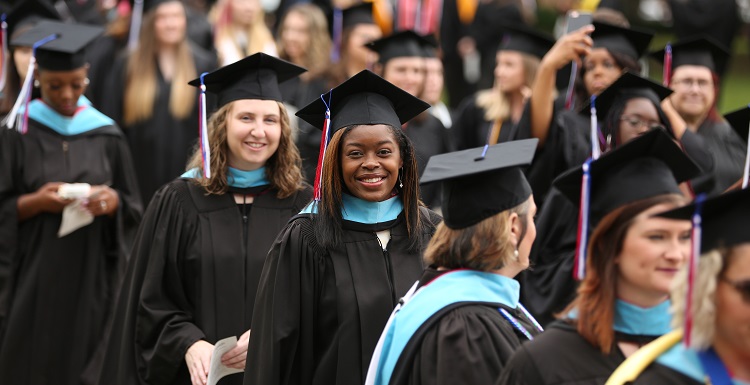 Ovie Mughelli, an environmental advocate and former NFL fullback, told graduates that "what you do has to be about more than a job, more than a paycheck. Your purpose in life is inside you."