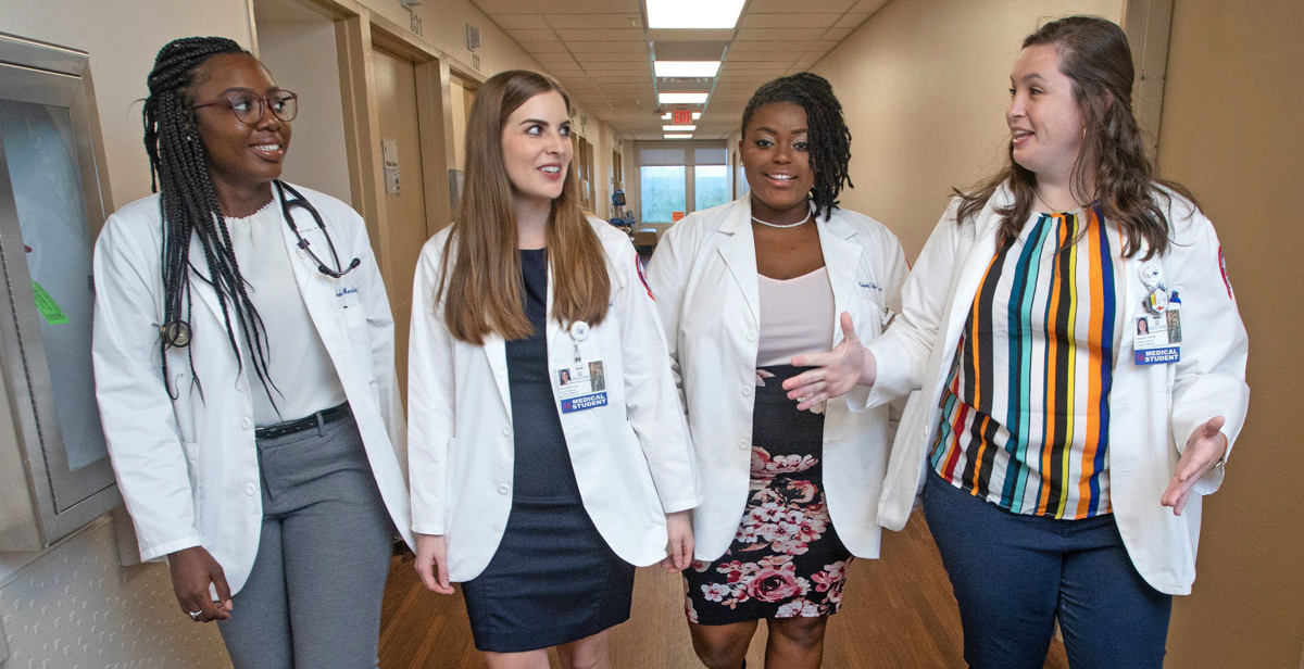 Angela Mosley-Johnson, Samantha Lee, Kimberly McWilliams and Hannah Brooks chat during a break in clinical rotations at USA Health University Hospital. The third-year students at the University of South Alabama College of Medicine have been awarded scholarships from Blue Cross and Blue Shield of Alabama as part of initiative to improve access to healthcare in underserved areas of the state.