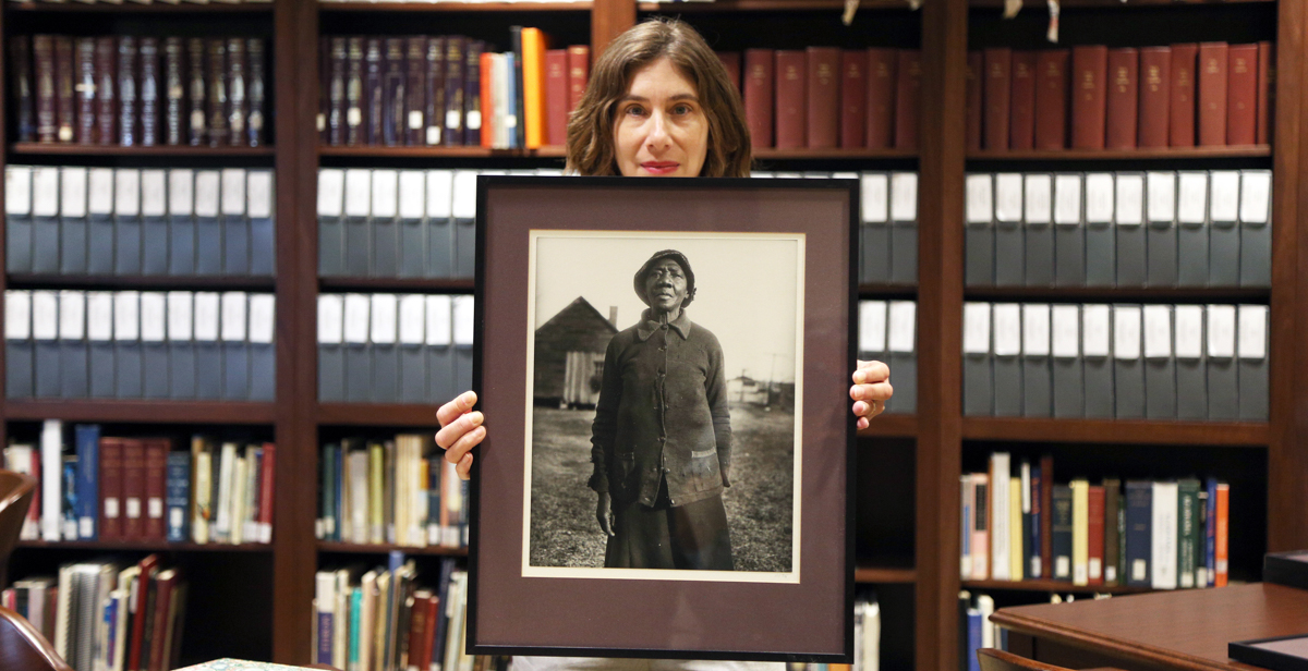 Deborah Gurt, archivist for the Doy Leale McCall Rare Book and Manuscript Library, holds one of the Eurdora Welty prints in the Iredale Collection donated to the University of South Alabama. The photo is one of a series taken by Welty as part of her job with the Works Project Administration during the Great Depression. 