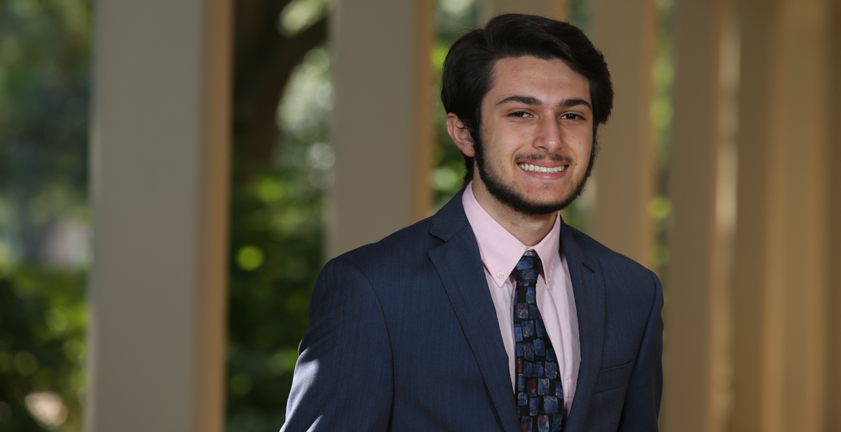 Stephen Azar, second from right, is the University of South Alabama Board of Trustees Scholar for the 2019-2020 academic year. Azar is a freshman from St. Patrick High School in Biloxi, Miss. The scholarship is awarded annually to the most academically talented student in each incoming freshman class at USA. Joining Azar at the USA Board of Trustees meeting are, from left, 2018 scholar Cody Dunlap of Mobile, 2017 recipient Ada Chaeli van der Zijp-Tan of Madison, Ala., 2016 recipient Christian Manganti of Gulfport, Miss., Board of Trustees chair pro tempore Jimmy Shumock; Rana Azar, Stephen Azar's mother; Azar, and University President Tony Waldrop. 
