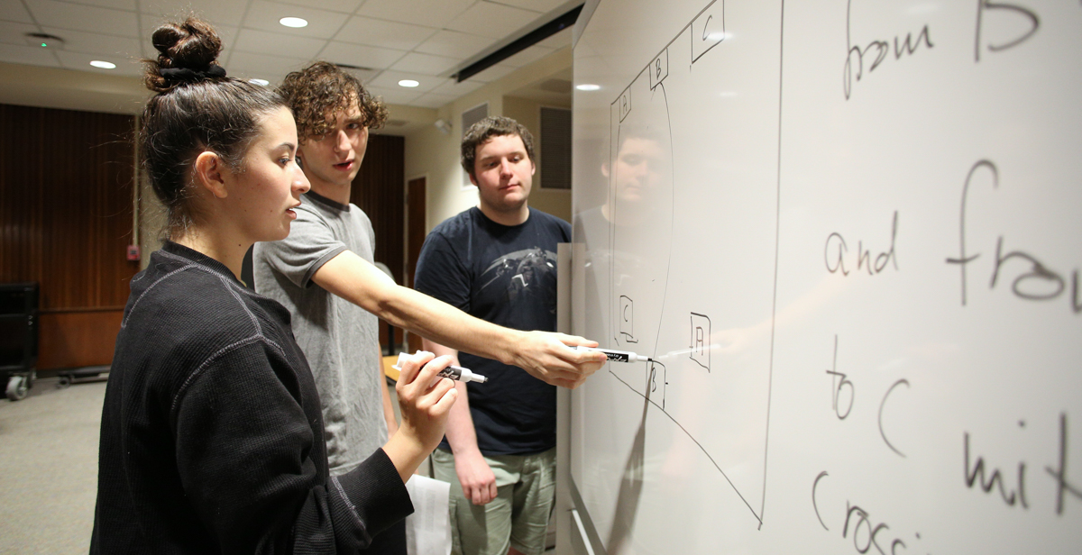 USA students John Pomerat, center, a sophomore computer science and mathematics major, along with Daniel Hodgins, a freshman engineering major, show Murphy High School student Mollee Bearden how to problem solve during a recent Math Circle session. data-lightbox='featured'
