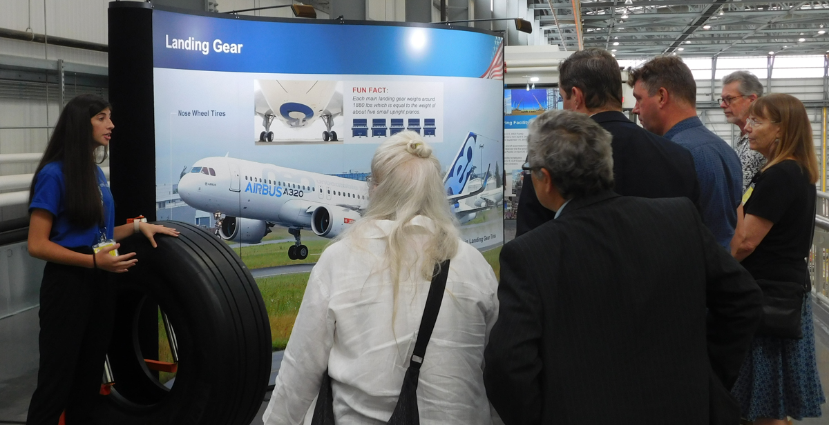 Emily Fogt, a freshman from Sidney, Ohio, explains to her tour group how the wings are attached to an Airbus plane. Fogt was among ten University of South Alabama hospitality and tourism management students who led tours of the Airbus Final Assembly Line facility for a recent conference. 