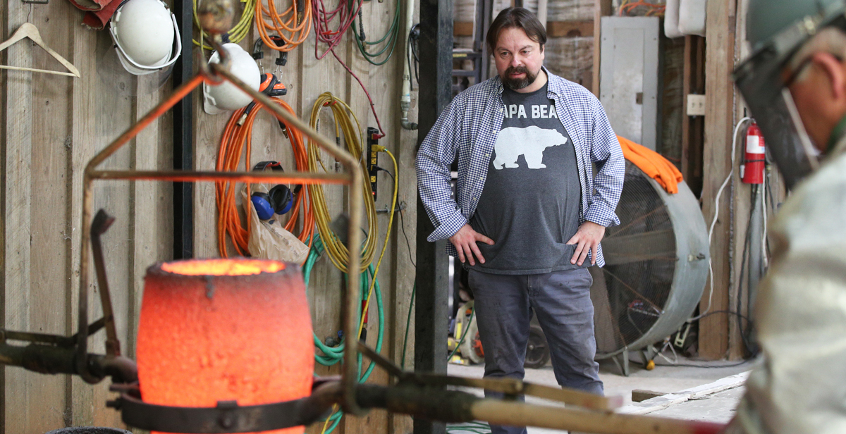 Fernando Guérard, a graduate student at the University of South Alabama, watches as his sculpture of Chief Calvin McGhee is being cast in bronze at the Fairhope Foundry. “This man, his humbleness and his honesty, I really connected with,” Guerard says. 