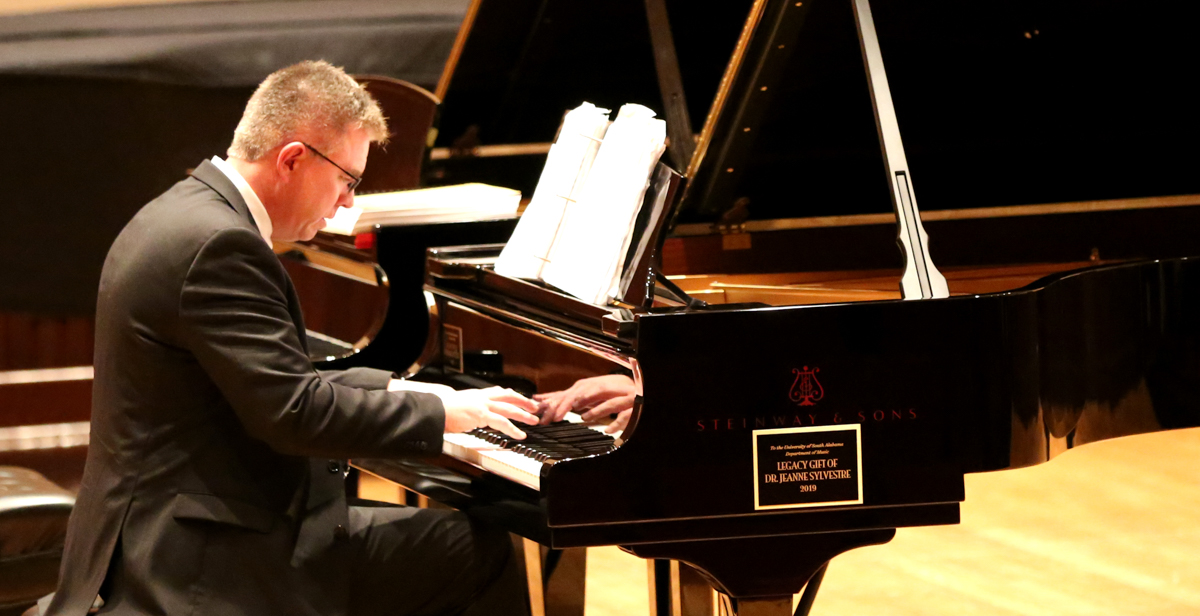 Dr. Robert Holm, professor of music at the University of South Alabama, plays on a Steinway recently donated to the department of music through a legacy gift by Dr. Jeanne Sylvestre, an emeritus professor of accounting.