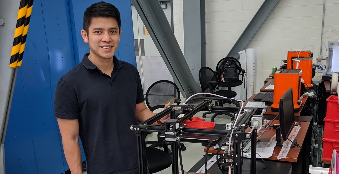 John Ding, who earned a master's in business administration from the University of South Alabama's Mitchell College of Business, is an aircraft engineer at Airbus and part of a team making medical masks for USA Health using 3D printers. Photo courtesy of Airbus. data-lightbox='featured'