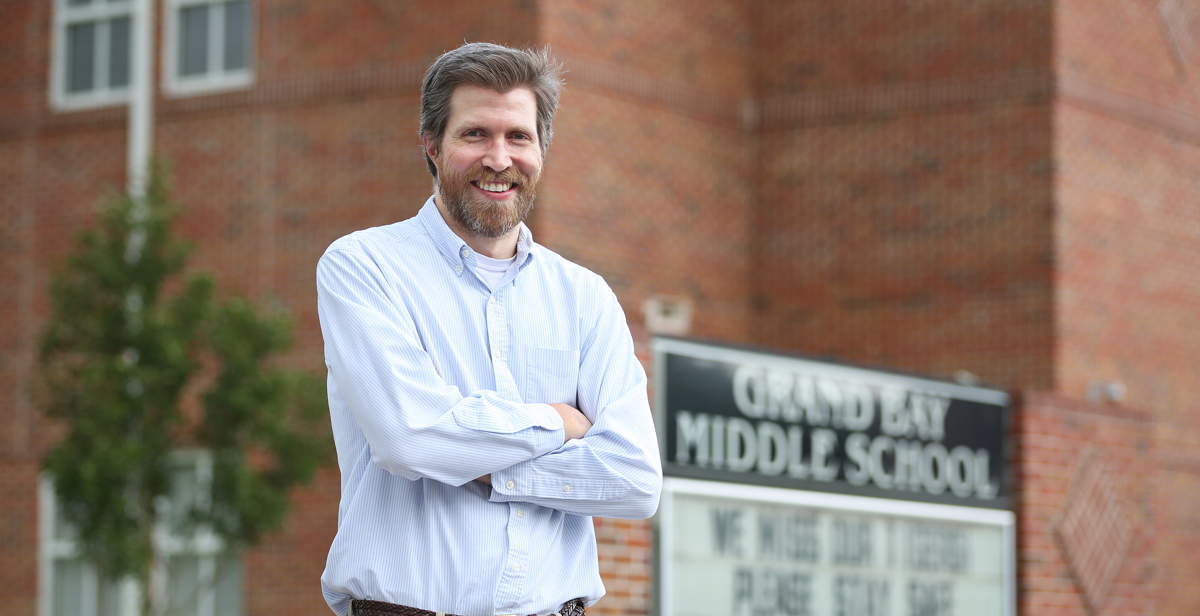 William DeMouy called the principal at Grand Bay Middle School the day he saw the job opening for a teacher. He interviewed the next morning. “I was thrilled. I was like, ‘Let’s do it. Let’s go for it.’”