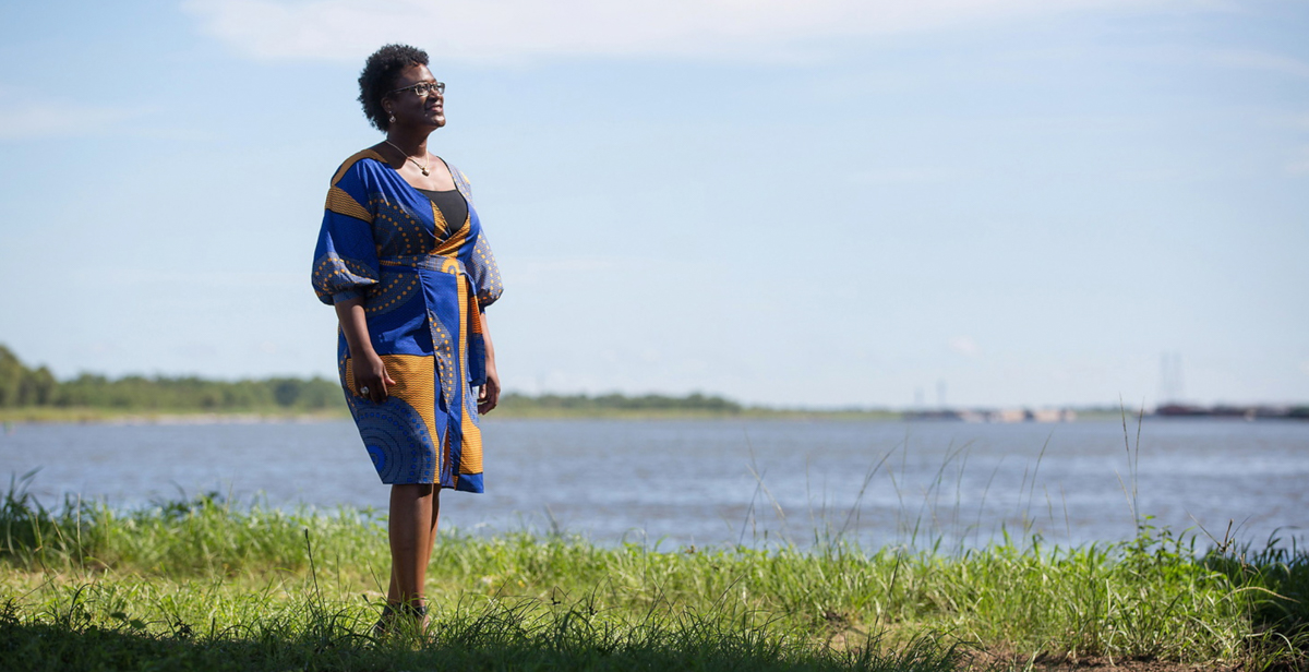 Dr. Joél Lewis Billingsley, associate professor in the University of South Alabama College of Education and Professional Studies, stands along the Mobile River in Africatown, where enslaved Africans aboard the Clotilda formed a community after arriving in America.